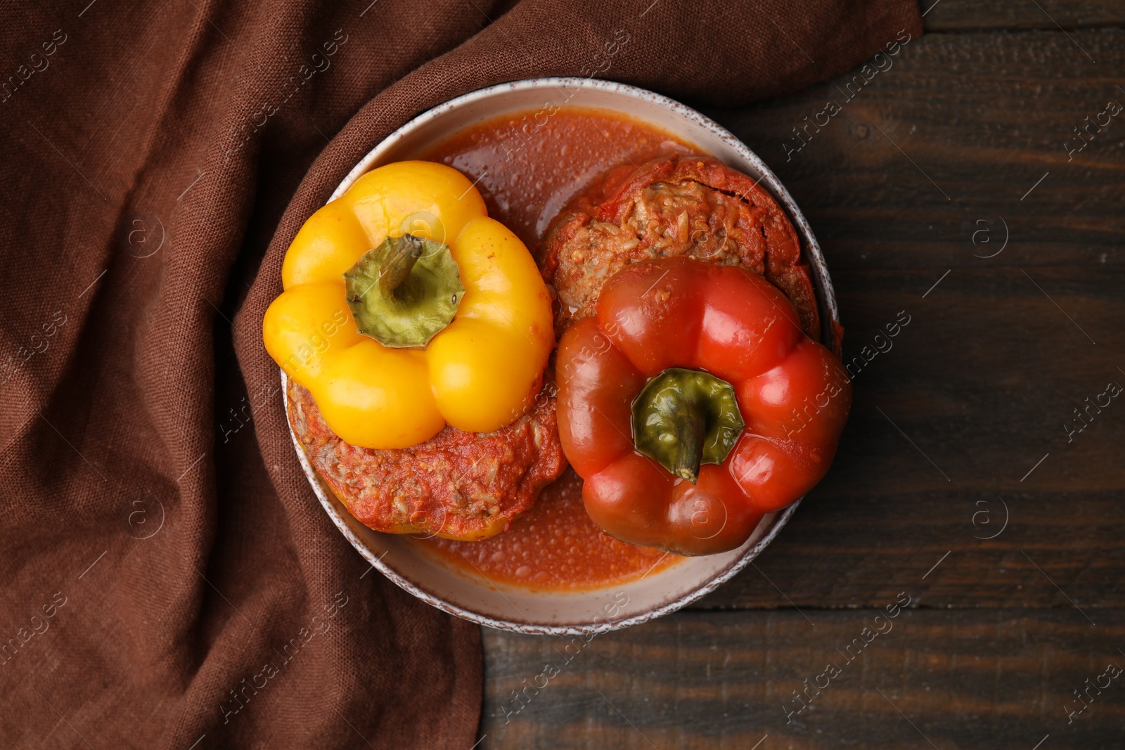 Photo of Delicious stuffed bell peppers on wooden table, top view