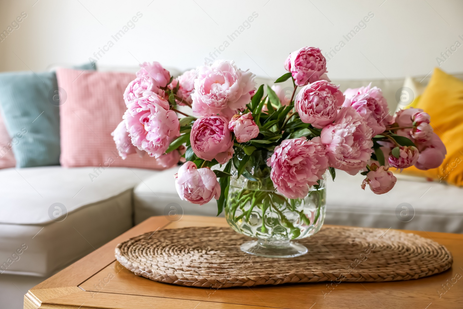 Photo of Beautiful pink peonies in vase on table at home. Interior design