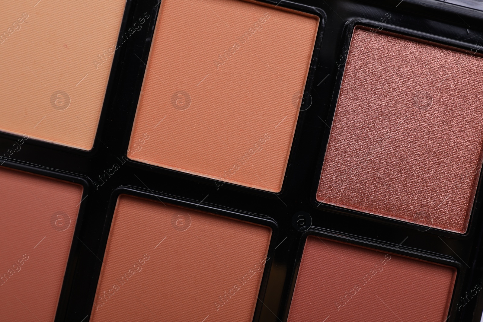 Photo of Colorful contouring palette as background, closeup. Professional cosmetic product