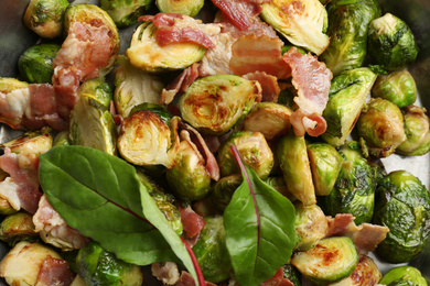 Photo of Delicious roasted Brussels sprouts with bacon in pan, top view