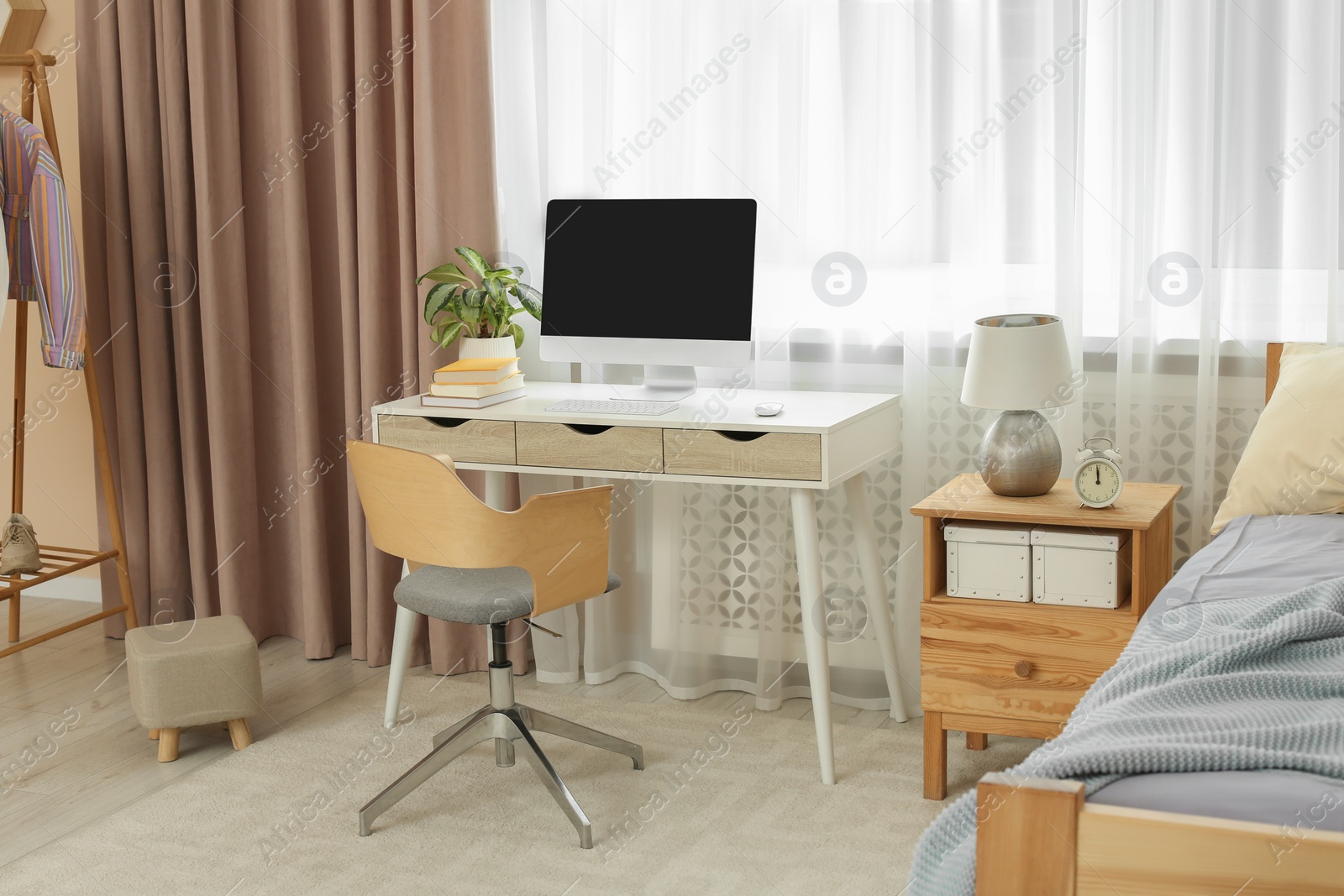 Photo of Stylish teenager's room interior with comfortable bed and workplace