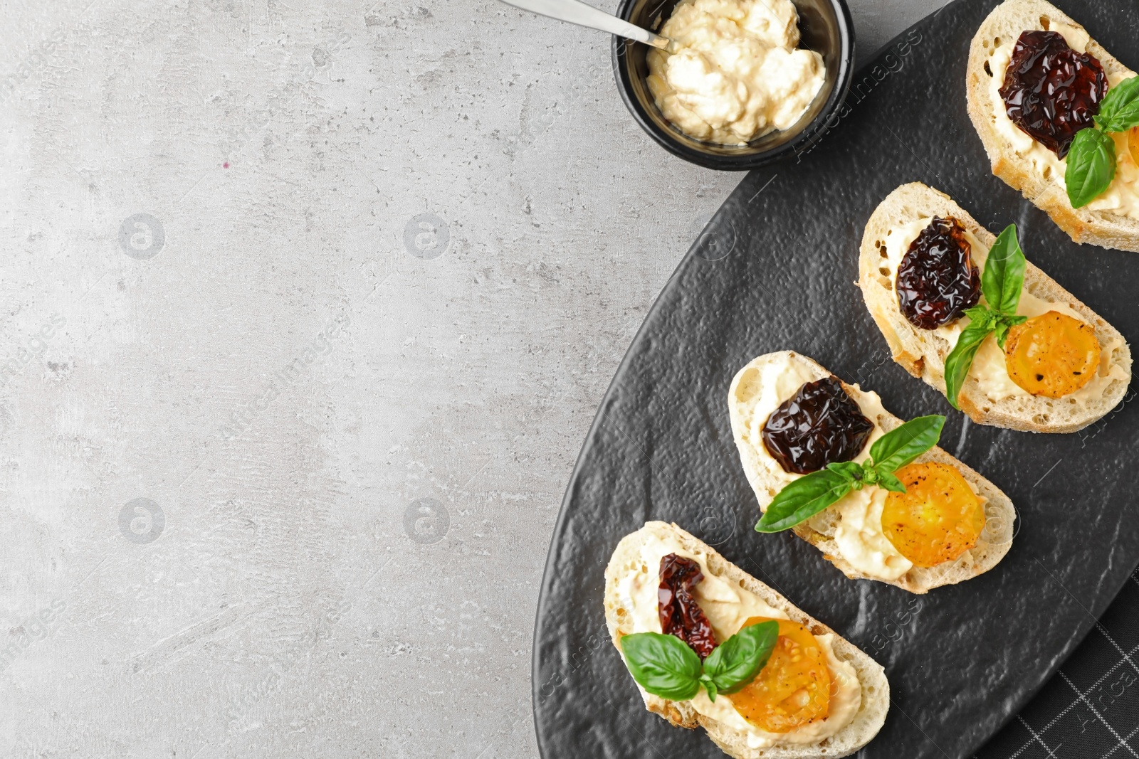 Photo of Tasty fresh tomato bruschettas on grey table, flat lay. Space for text