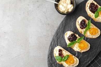 Photo of Tasty fresh tomato bruschettas on grey table, flat lay. Space for text