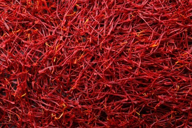 Photo of Red dried saffron as background, top view