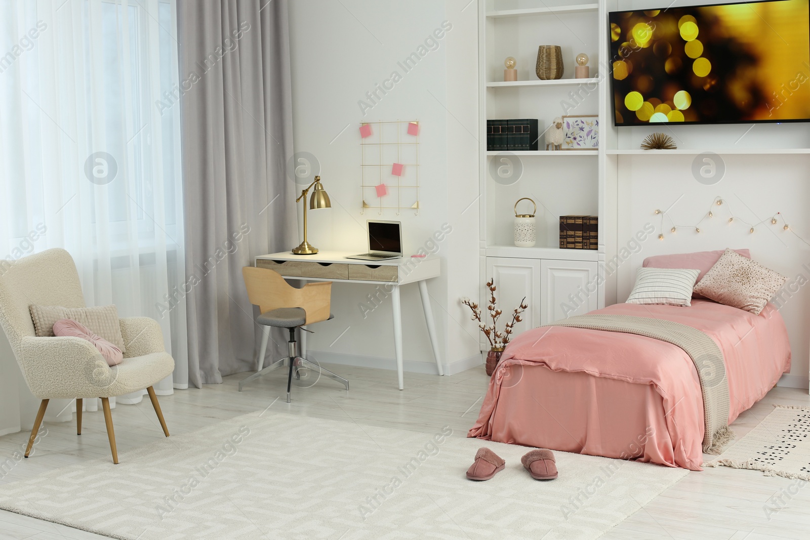 Photo of Stylish teenager's room interior with comfortable bed, workplace and modern TV set