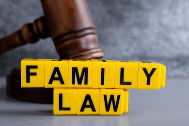 Photo of Cubes with words Family Law and gavel on grey table