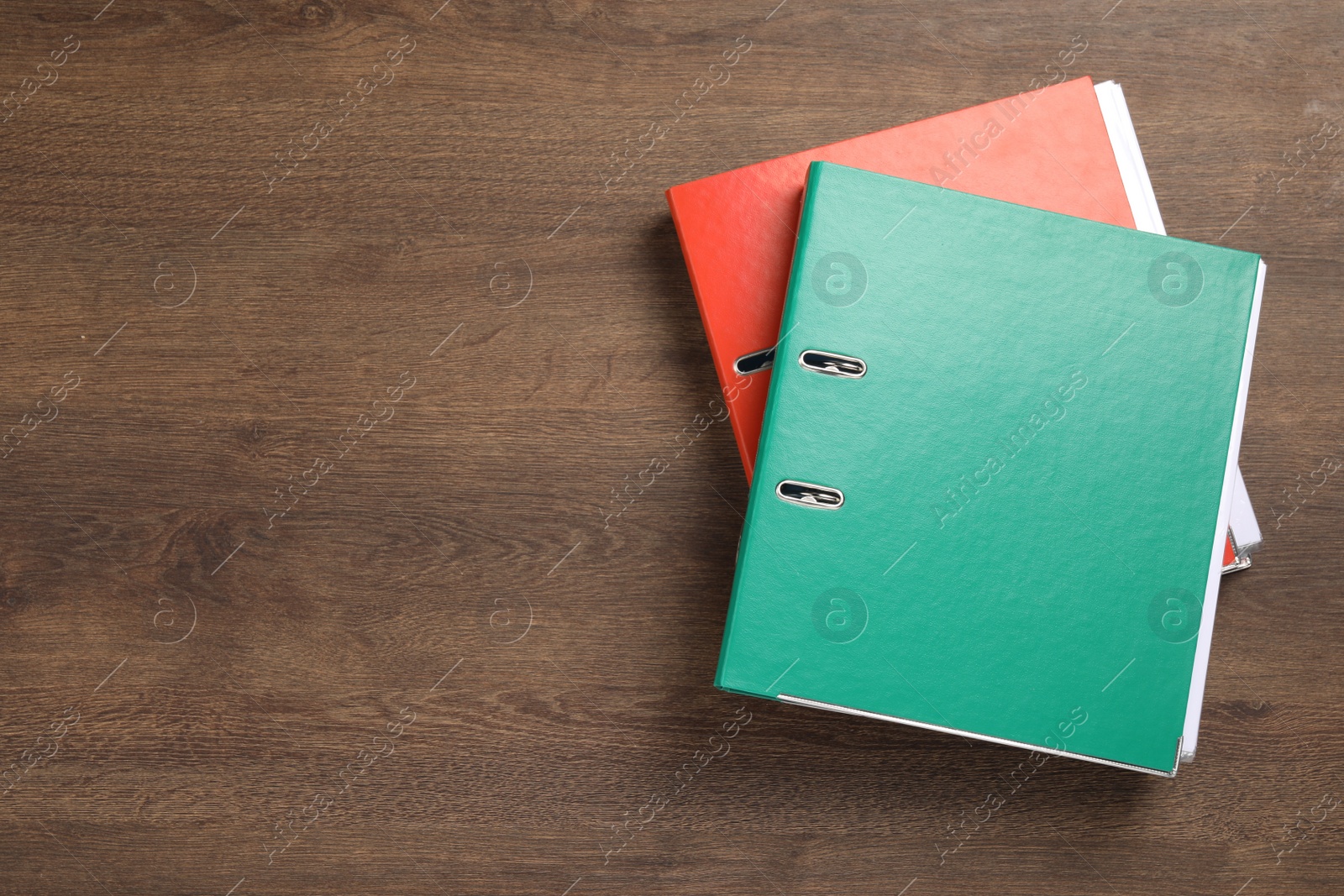 Photo of Office folders on wooden table, flat lay. Space for text