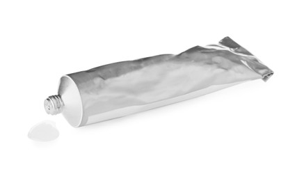 Photo of Blank tube and drop of glue on white background