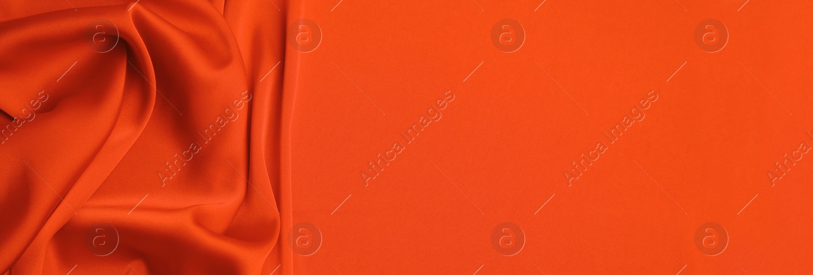 Image of Orange silk fabric as background, top view with space for text. Banner design