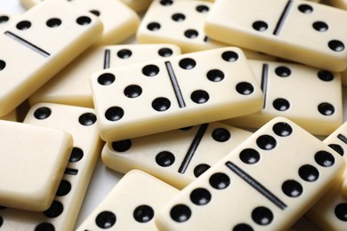 Photo of Set of classic domino tiles on white background, closeup