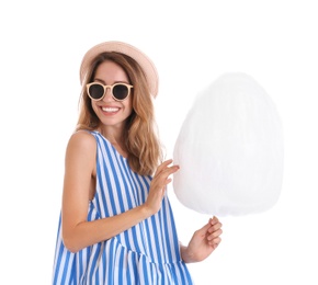 Photo of Happy young woman with cotton candy on white background