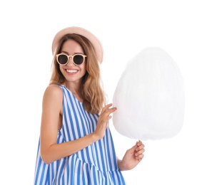 Happy young woman with cotton candy on white background