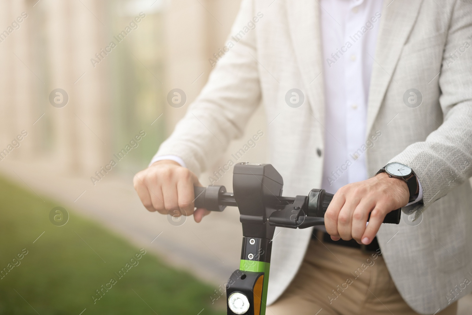 Photo of Businessman with modern kick scooter on city street, closeup. Space for text