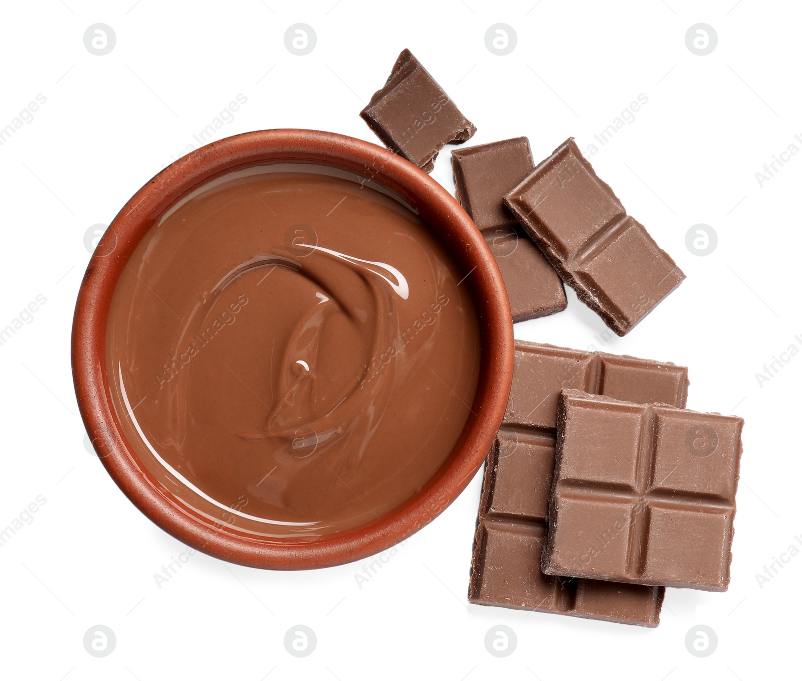 Photo of Tasty milk chocolate paste in bowl and pieces isolated on white, top view