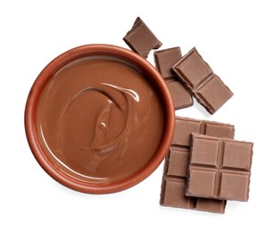 Tasty milk chocolate paste in bowl and pieces isolated on white, top view