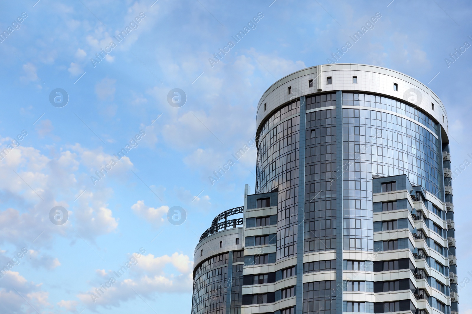 Photo of Low angle view of modern city building against sky. Space for text