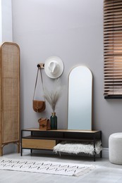 Photo of Stylish hallway interior with mirror and table near light wall
