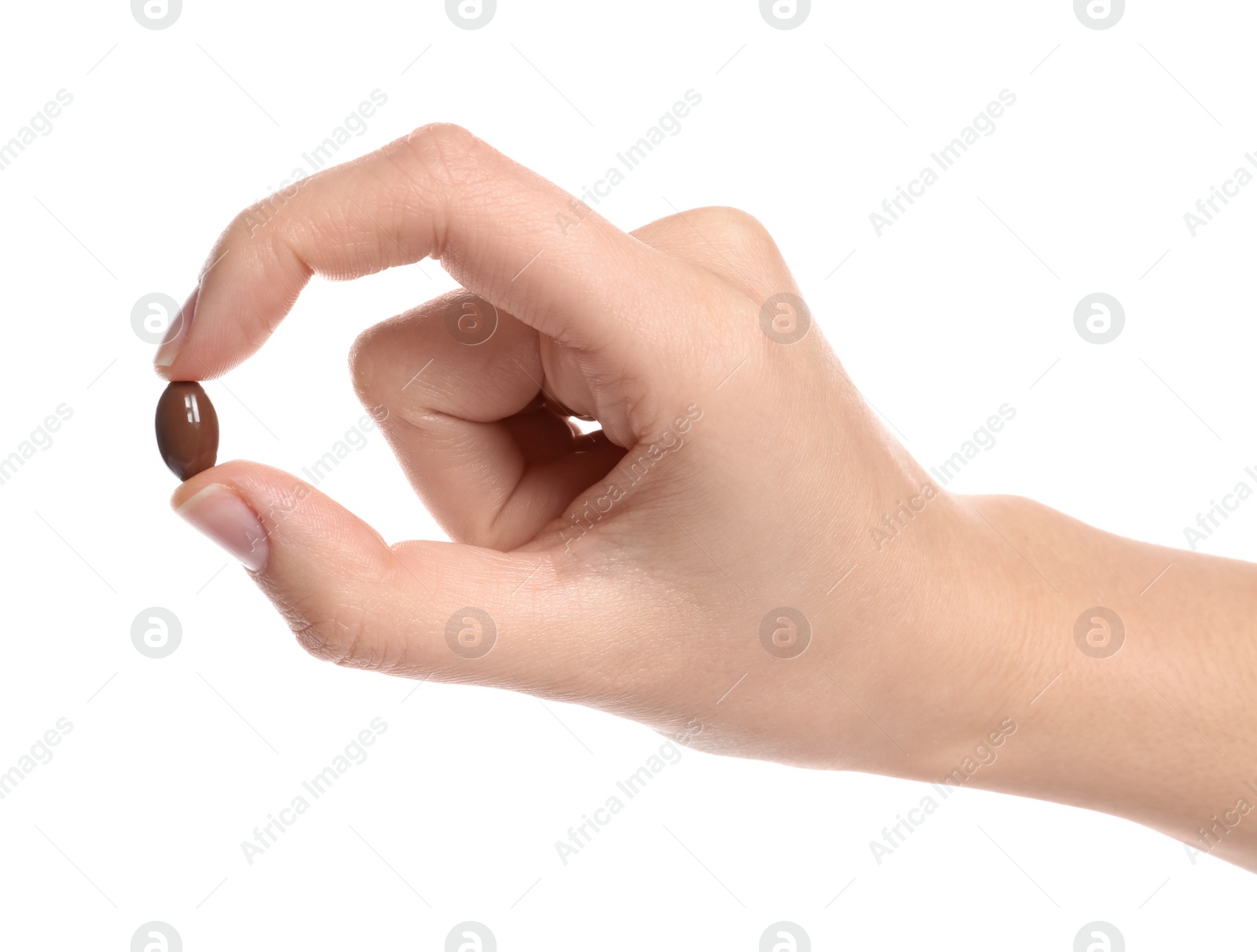 Photo of Woman holding color pill on white background, closeup