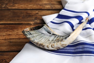 Shofar and Tallit on wooden table. Rosh Hashanah holiday attributes