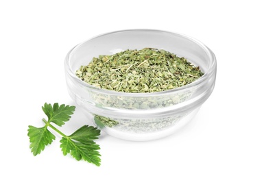 Photo of Bowl with dried parsley and fresh twig on white background