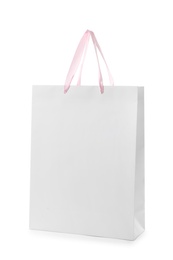 Photo of Paper shopping bag with handles on white background. Mockup for design