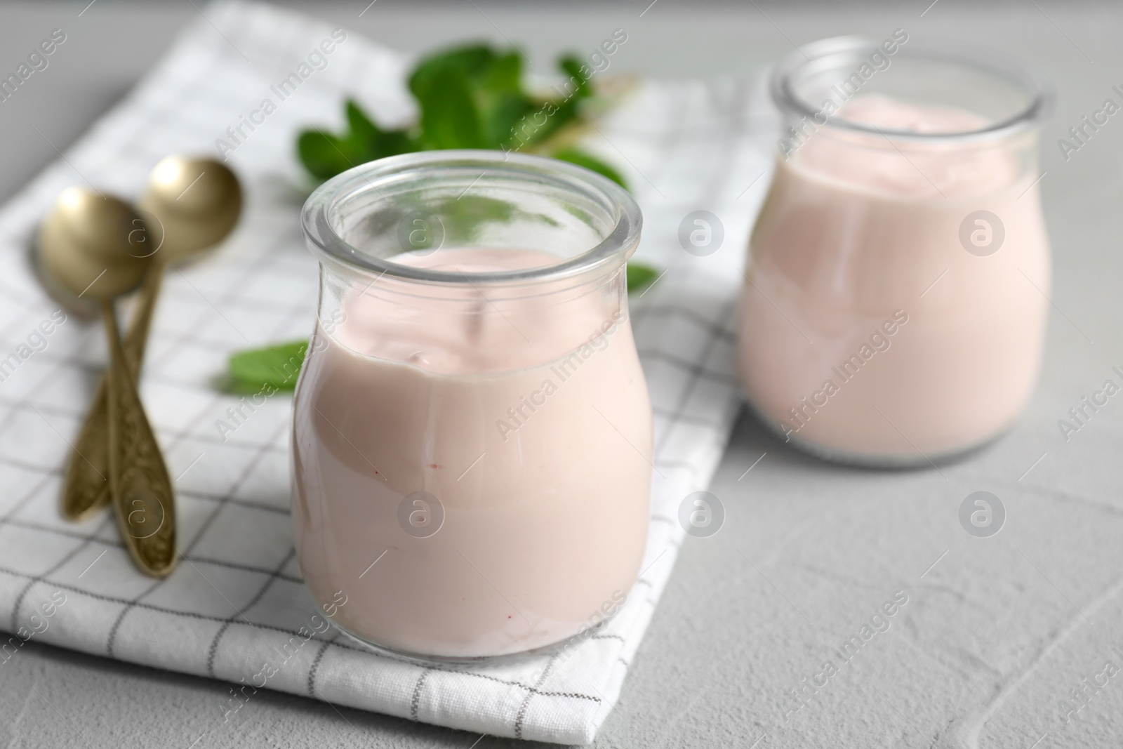 Photo of Jars with yummy yogurt on table