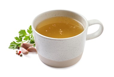 Hot delicious bouillon in cup and ingredients on white background