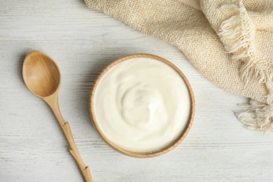 Photo of Tasty organic yogurt on white wooden table, flat lay