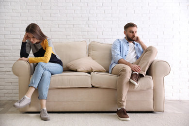 Photo of Unhappy couple with problems in relationship at home
