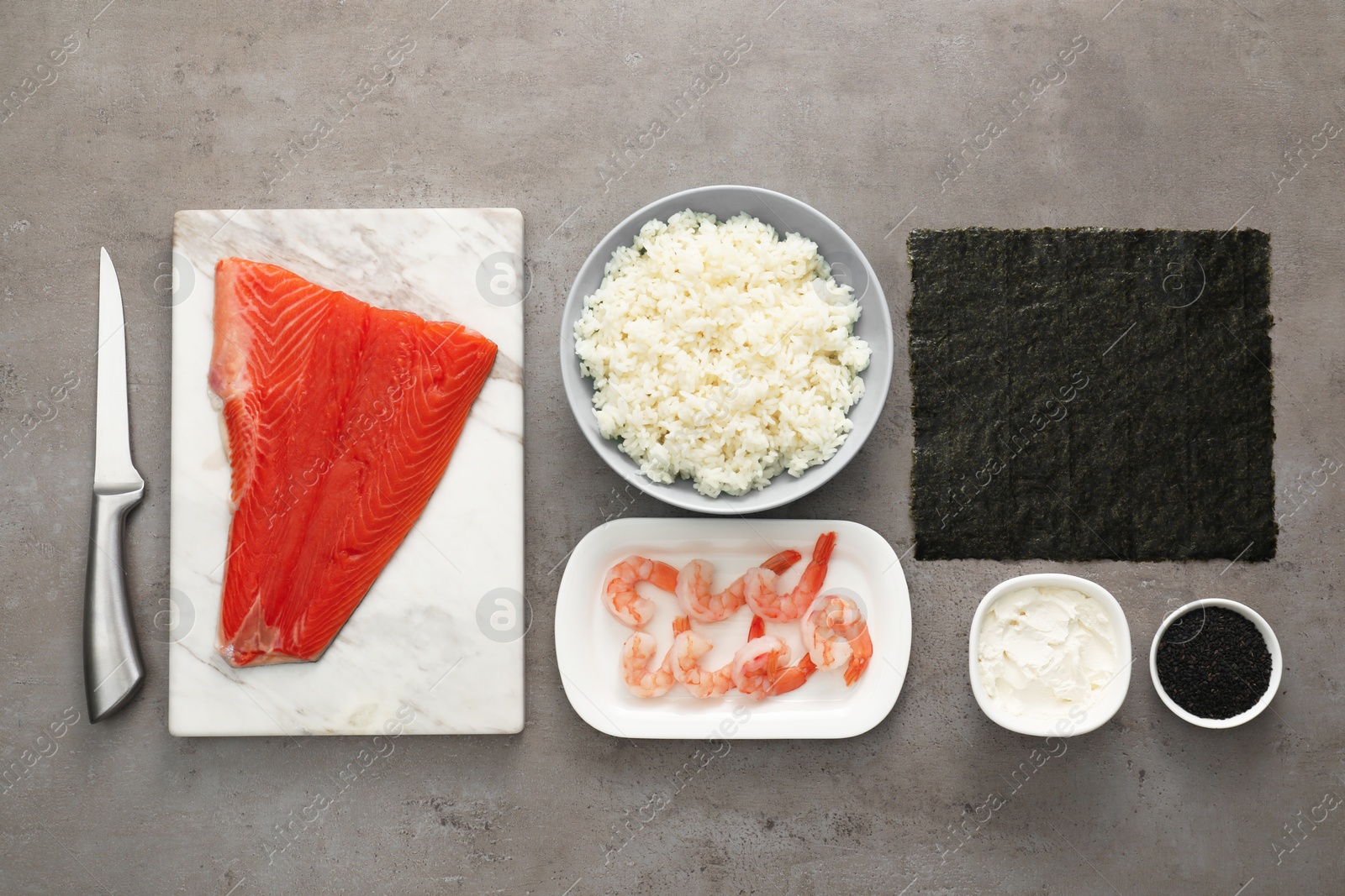 Photo of Flat lay composition with ingredients for sushi on grey textured table