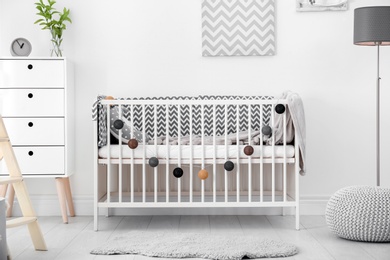 Photo of Baby room interior with comfortable crib