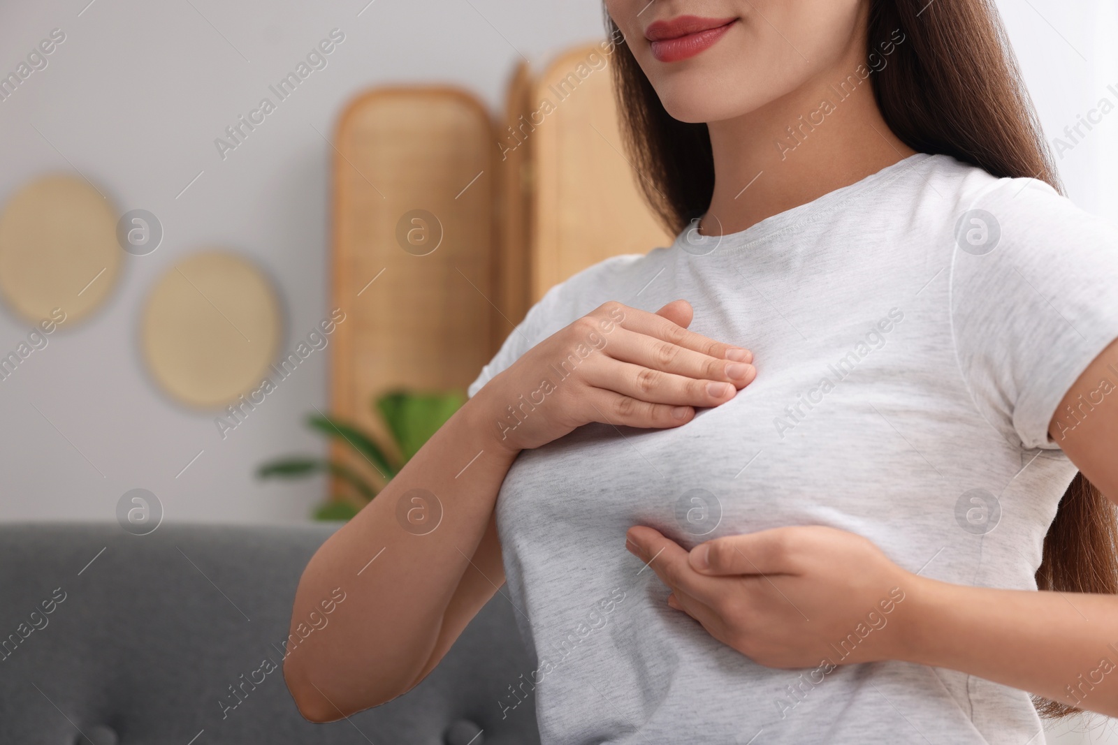 Photo of Woman doing breast self-examination at home, closeup. Space for text