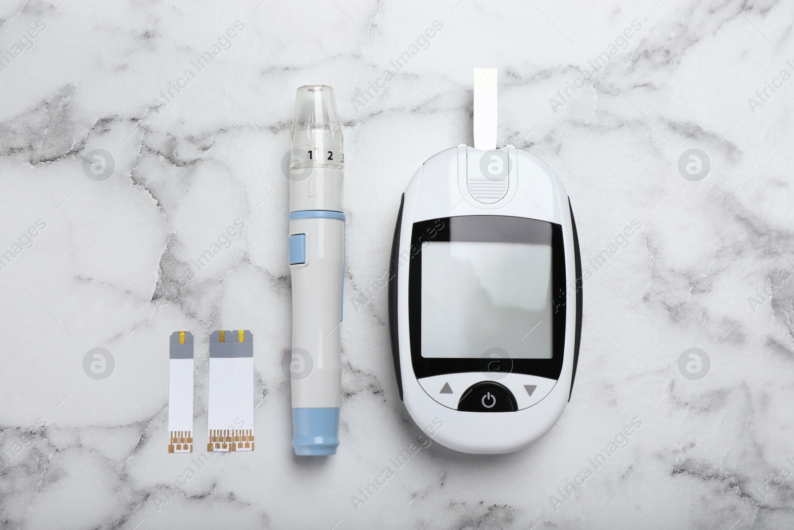 Photo of Glucometer, lancet pen and strips on white marble table, flat lay. Diabetes testing kit