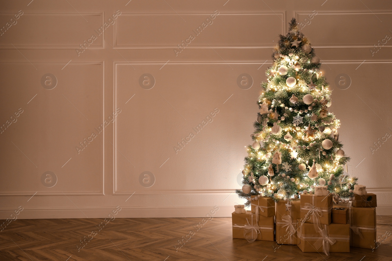 Photo of Beautiful decorated Christmas tree and gifts indoors. Space for text