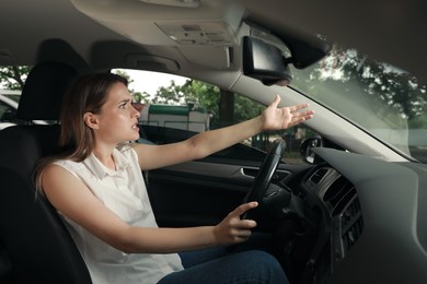 Photo of Stressed young woman in driver's seat of modern car