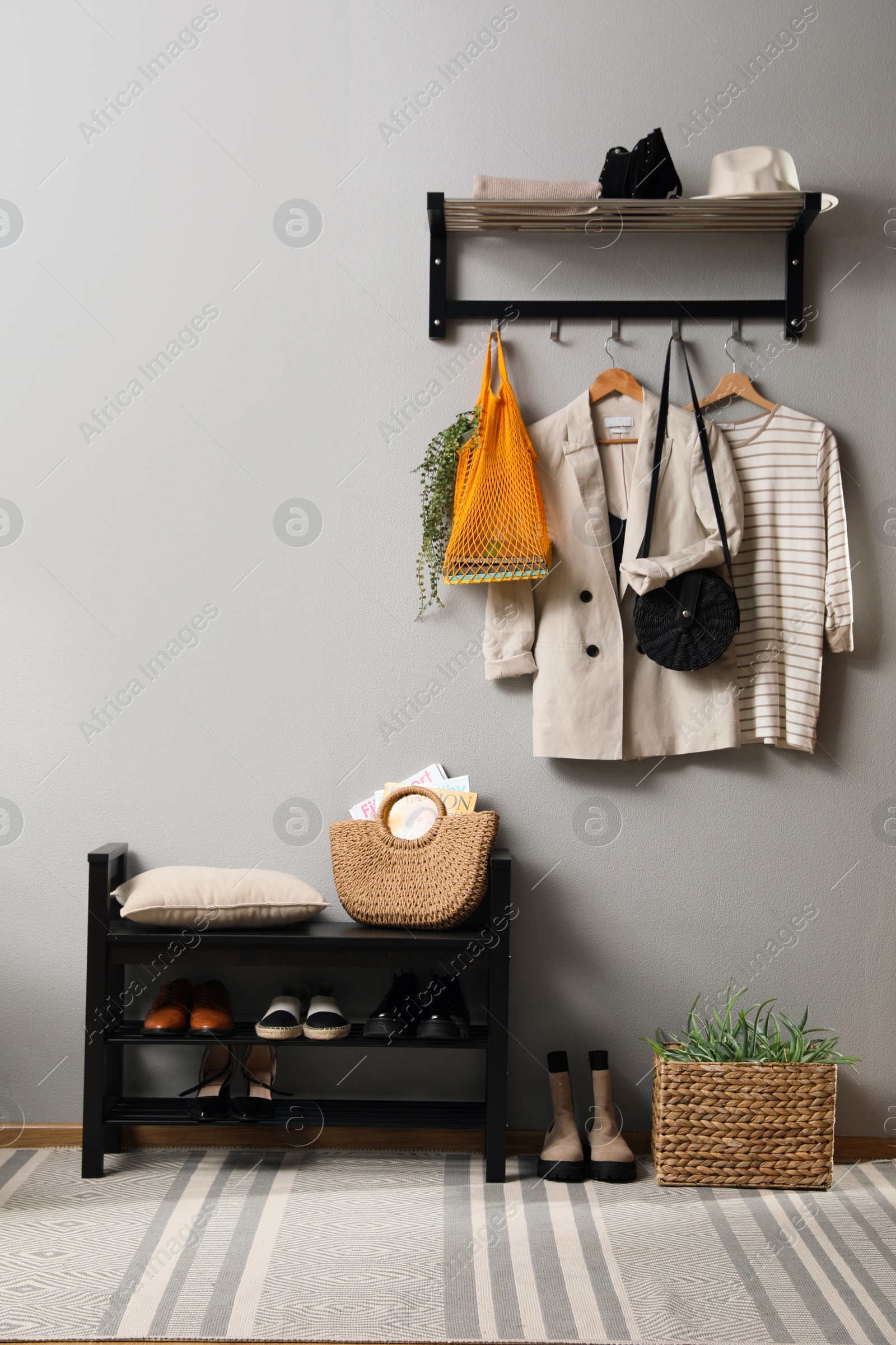 Photo of Hallway interior with stylish furniture, clothes and accessories