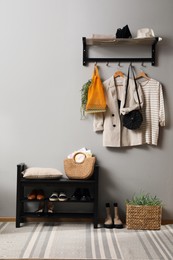 Hallway interior with stylish furniture, clothes and accessories