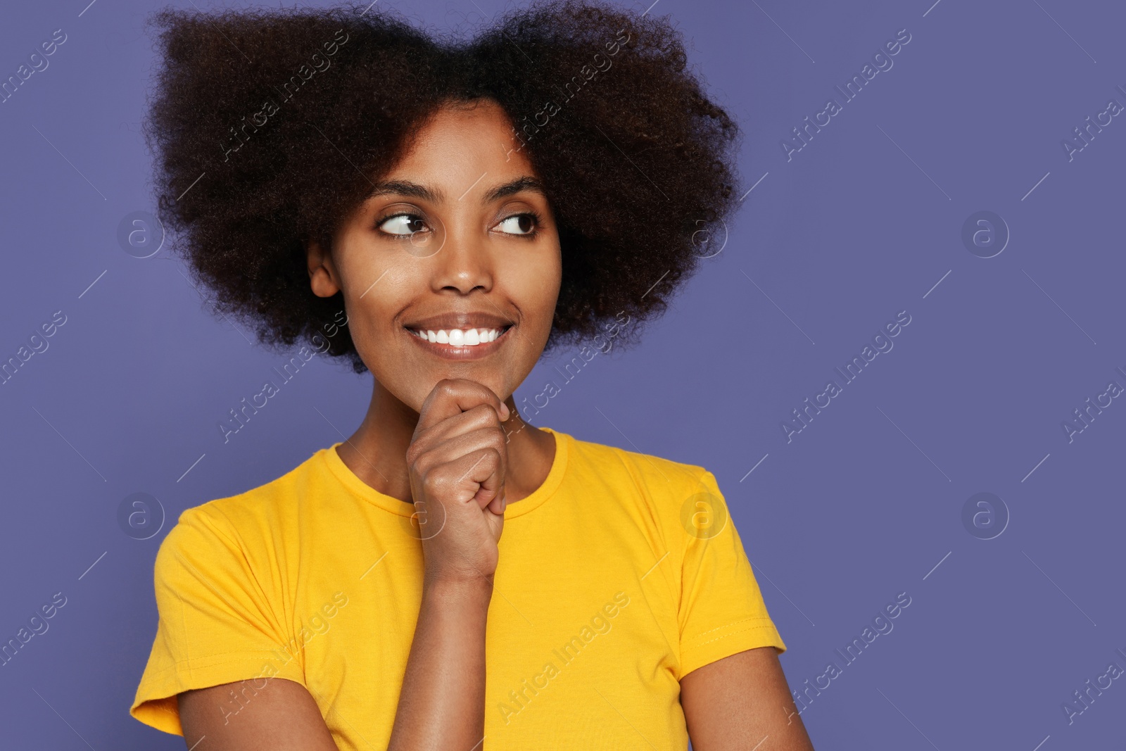 Photo of Portrait of smiling African American woman on purple background. Space for text