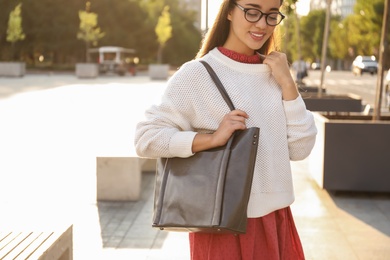 Young woman with stylish shopper bag outdoors