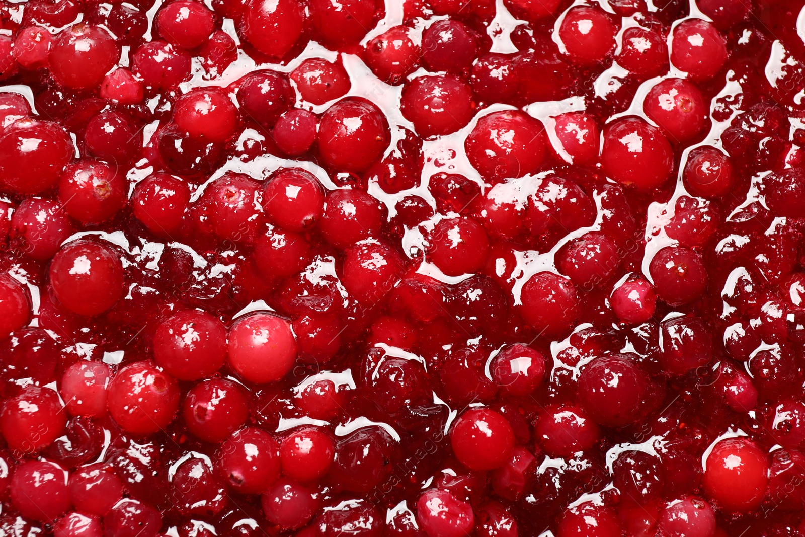 Photo of Fresh juicy cranberry sauce as background, closeup