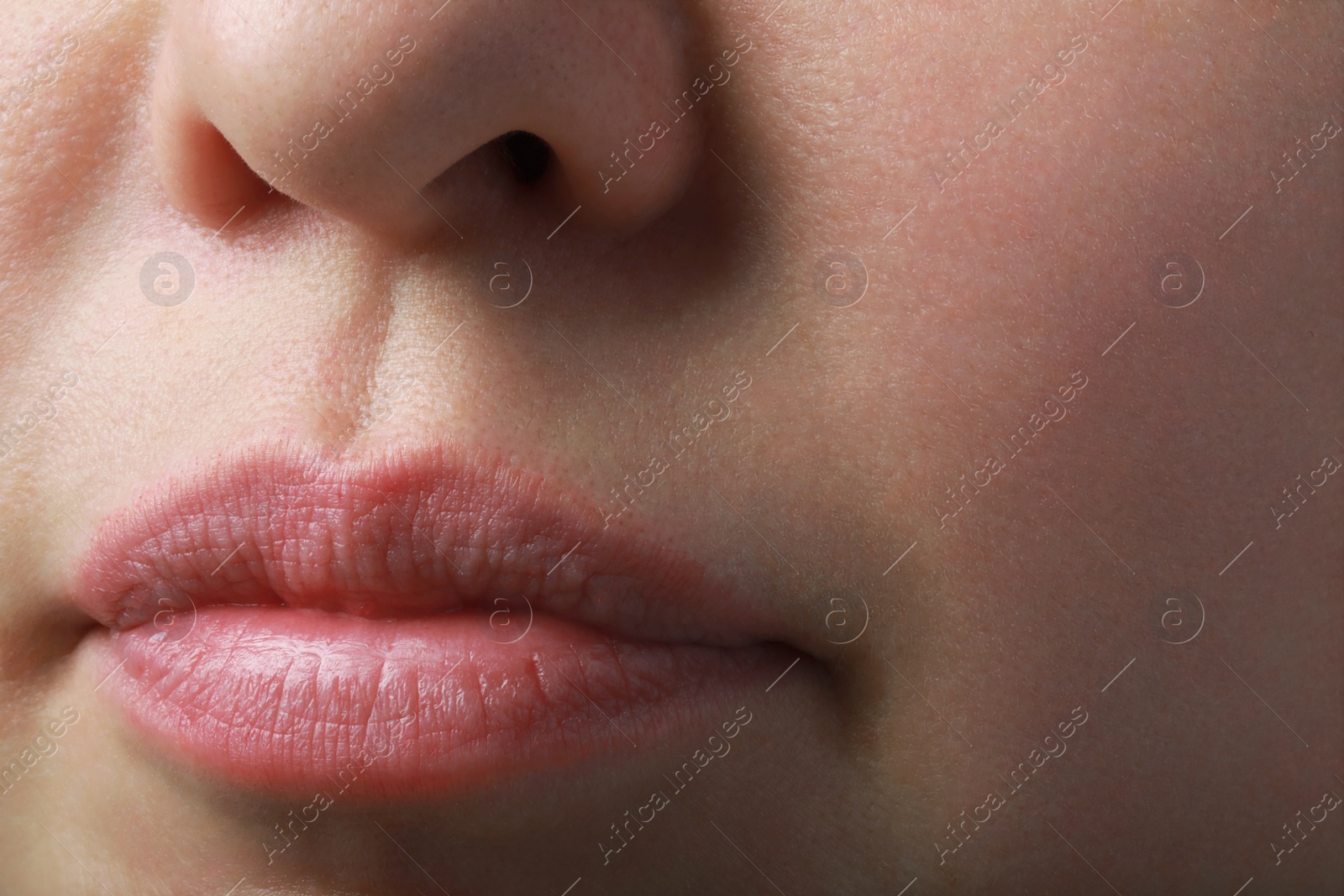 Photo of Closeup view of woman with normal skin and beautiful lips