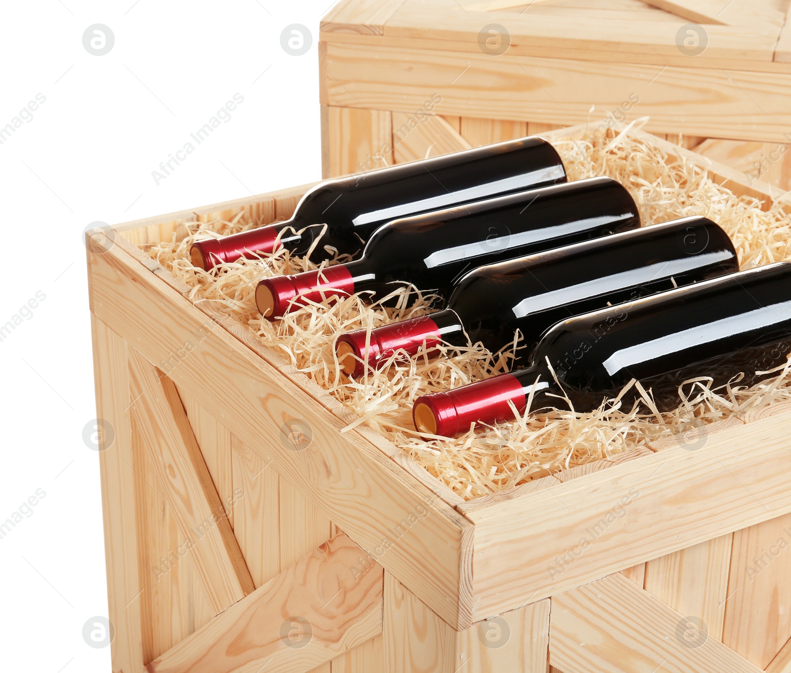 Photo of Wooden crate with bottles of wine isolated on white, closeup