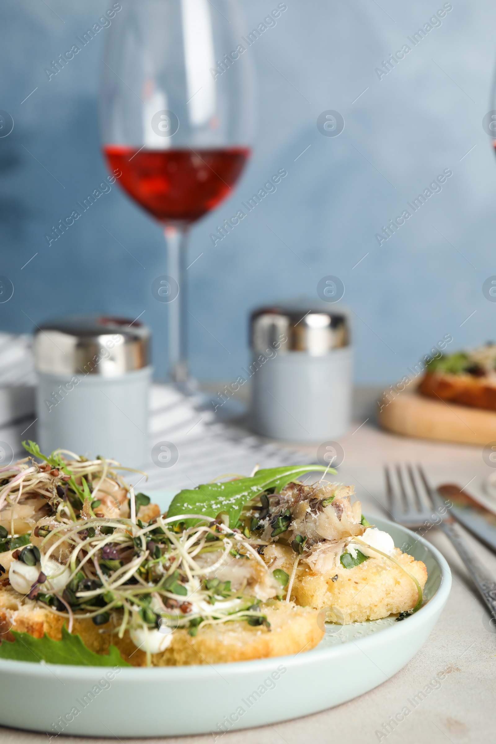 Photo of Delicious bruschettas with fish on light table