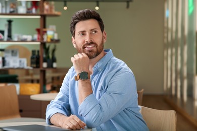 Portrait of handsome stylish man in cafe