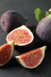 Fresh ripe figs on black table, closeup