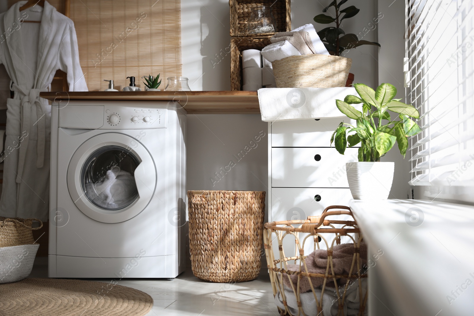 Photo of Stylish bathroom interior with modern washing machine