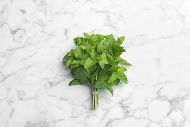 Bunch of fresh mint on white marble  background, top view