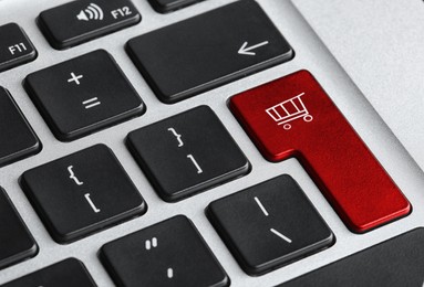 Image of Online store. Red button with shopping cart on computer keyboard, closeup