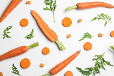 Tasty ripe carrots and leaves isolated on white, top view