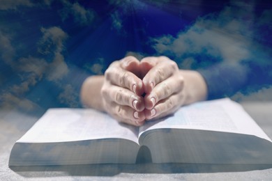 Religion. Double exposure of sky and Christian woman praying over Bible at table, closeup